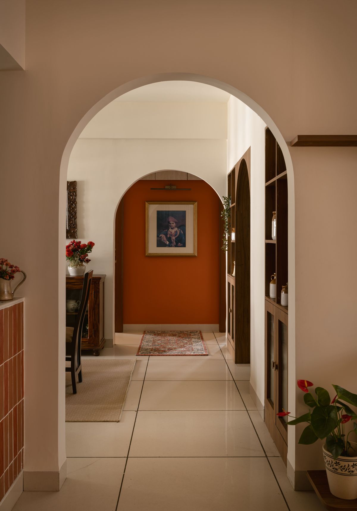 Corridor of arches leading to a terracotta wall