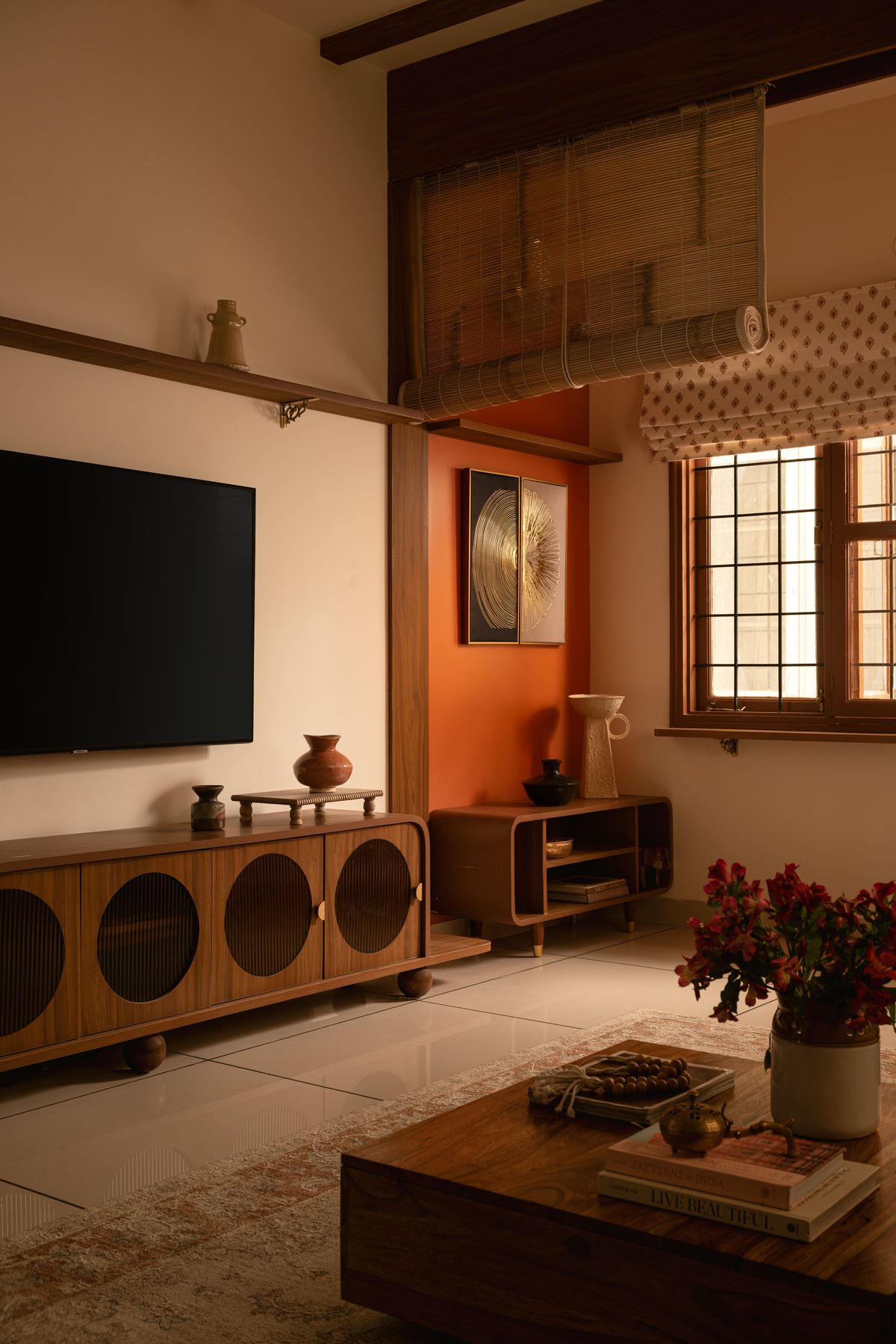 Media wall at dusk with fluted-oval console and burnt-orange niche