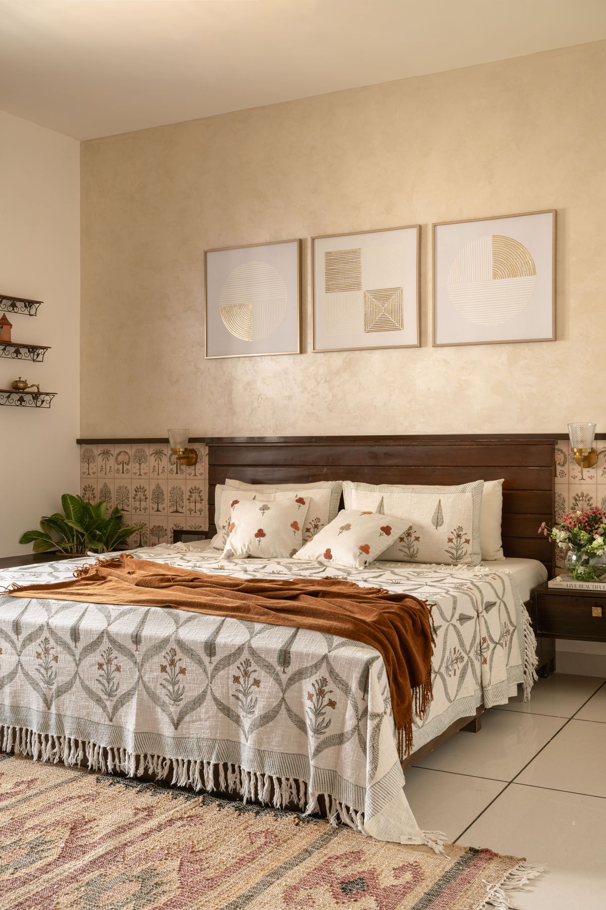 Master bedroom with lime-plaster wall, dark wood headboard and block-printed linen