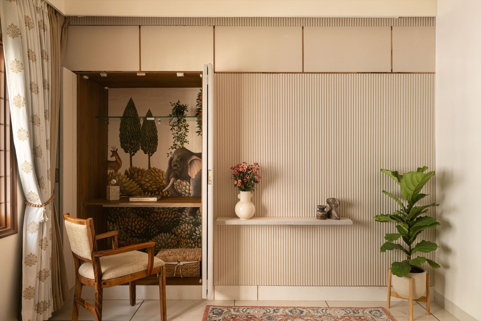 Fluted wall panels folding open to reveal a mural-lined study nook